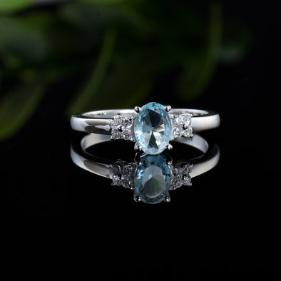 7x5mm Oval Blue Topaz Ring with side Accents - 925 Sterling Silver