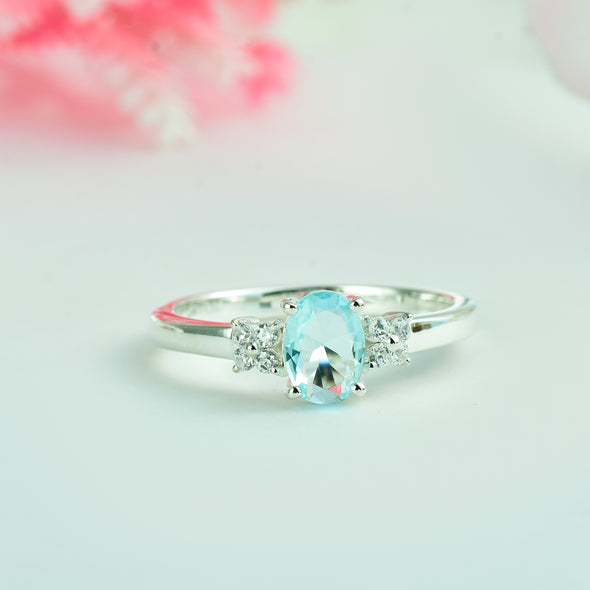 7x5mm Oval Blue Topaz Ring with side Accents - 925 Sterling Silver