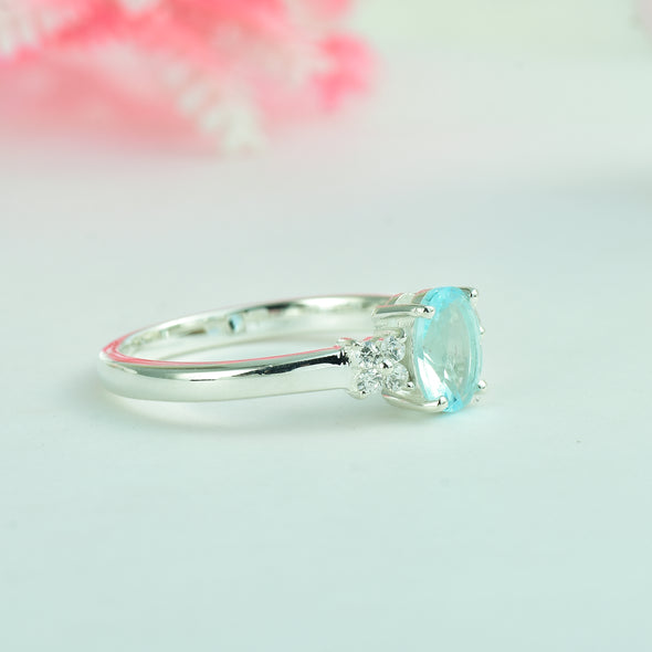 7x5mm Oval Blue Topaz Ring with side Accents - 925 Sterling Silver