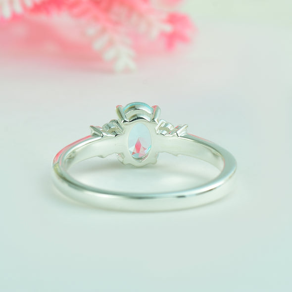 7x5mm Oval Blue Topaz Ring with side Accents - 925 Sterling Silver